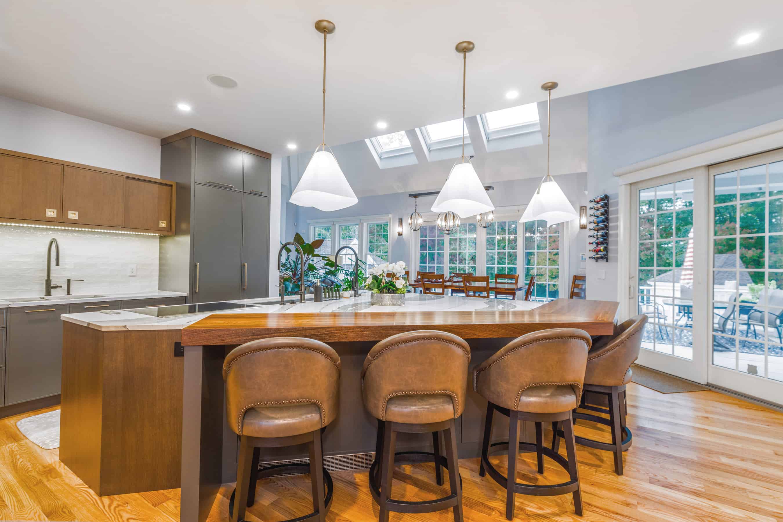 A modern style kitchen featuring slab-style cabinetry and an oversized island with plenty of seating and prep space. 