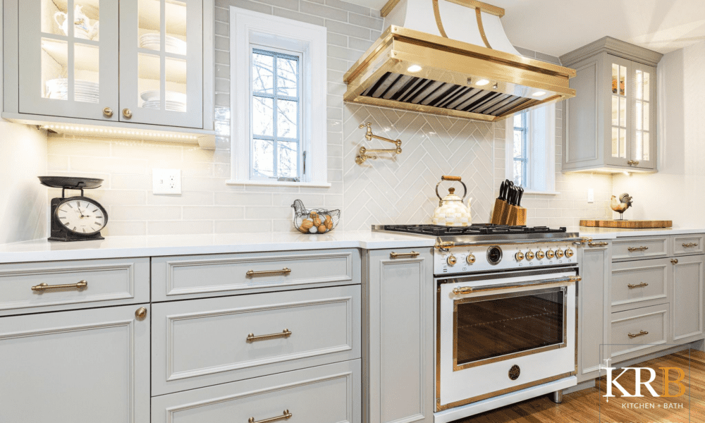 French inspired kitchen with gold and white kitchen hood and oven