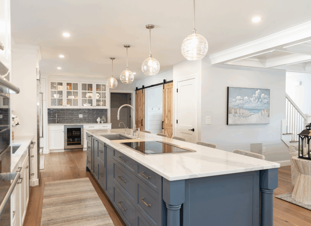 Kitchen island with statement pendant lighting and layered illumination