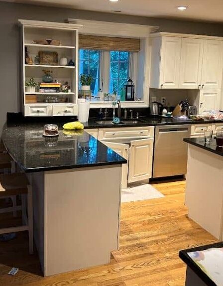 The bright white cabinetry and oversized peninsula welcome you into the kitchen. 